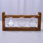 Laboratory glassware with three flasks in a wooden stand for science experiments.