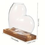Heart-shaped glass vase for home decor and gifts, featuring a clear, elegant design with a wooden base. Perfect for floral arrangements or as a decorative piece.
