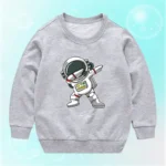 Gray children's sweatshirt featuring a cartoon astronaut in a space suit, standing with one arm raised, on a light blue background. Perfect for kids interested in space and science.