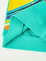 Bright turquoise hoodie with colorful abstract design on the sleeve.