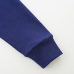 Close-up of a blue sleeve cuff from a science-themed educational hoodie, highlighting the fabric and stitching details.