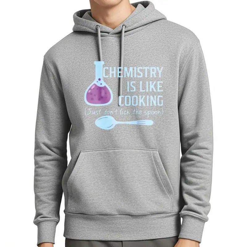Chemistry Hoodie | Mode scientifique et décontractée Sweat à capuche gris avec slogan scientifique "Chemistry is like cooking" illustré d'une fiole et d'une cuillère, parfait pour les amateurs de science et de mode décontractée.
