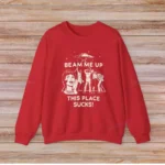 Red sweatshirt featuring a humorous sci-fi design with a UFO, a woman, and aliens, with the text "BEAM ME UP THIS PLACE SUCKS!" perfect for science and space lovers.