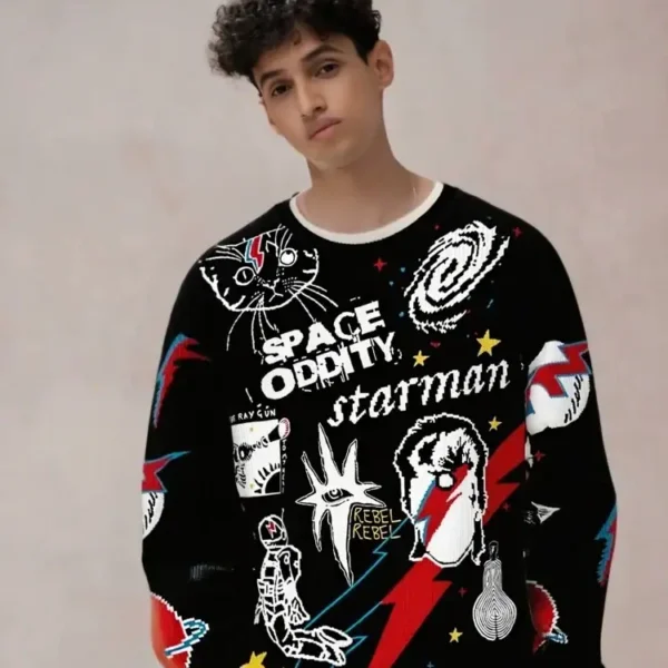 Un jeune garçon portant un pull à motifs d'espace, de planètes, d'astronautes et de thèmes cosmiques, illustrant la mode inspirée de la science et de l'univers.