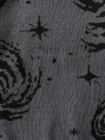 Close-up of fabric with a starry night pattern featuring black stars and swirling designs on a gray background.