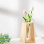 Elegant wooden vase holding pink and white tulip flowers, perfect for home decoration and adding a touch of nature to any space.