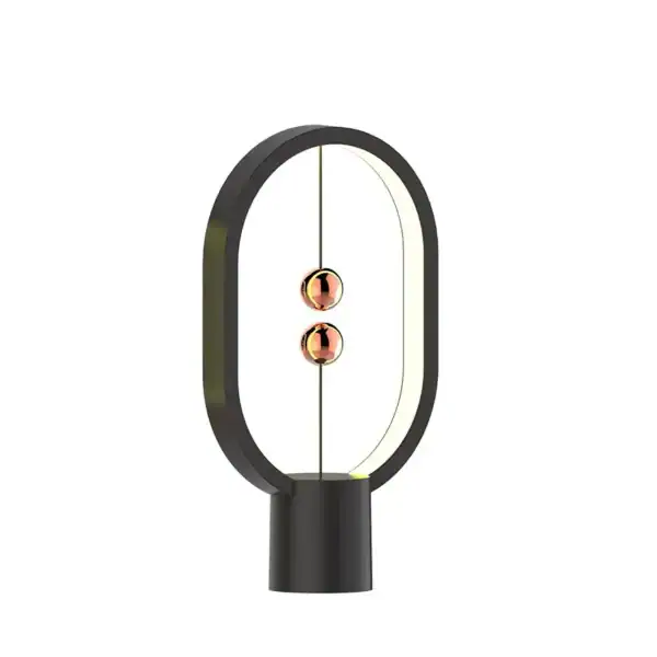 Modern magnetic levitation science toy with a sleek black base and two copper-colored magnetic spheres suspended in mid-air, demonstrating magnetic repulsion.
