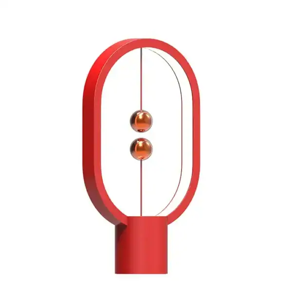 A modern magnetic levitation science toy featuring a red oval frame with two floating copper-colored spheres suspended by magnetic forces.